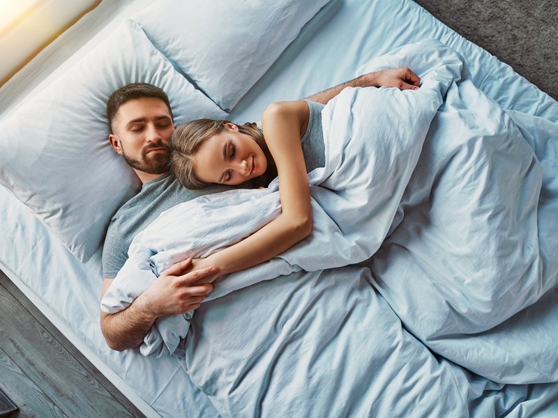 Young couple sleeping in bed