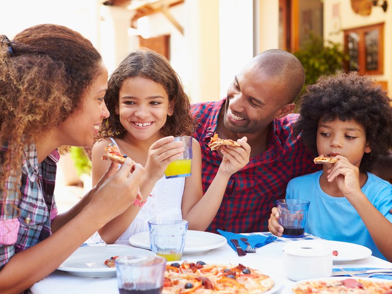 Family eating meal at outdoor restaurant
