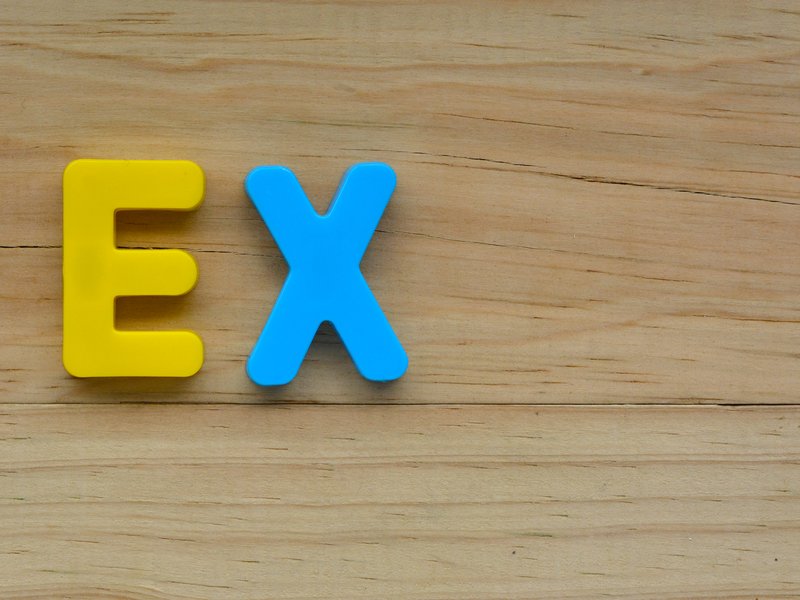 Flat lay of the word Ex on a wooden background