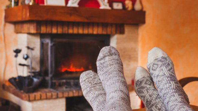 Cozy family evening near fireplace / iStock