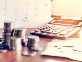 Budgeting with a calculator / iStock