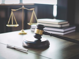 Gavel on wooden table / iStock