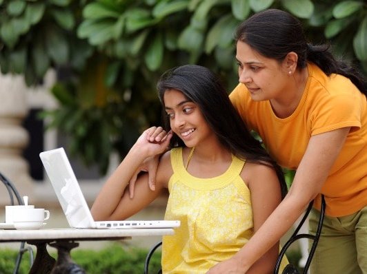 Mom daughter laptop studying outdoors