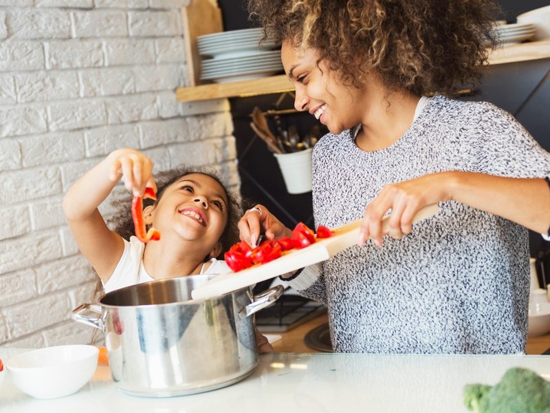 Mom daughter cooking vegetables