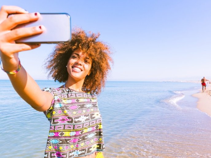 Woman travel phone selfie beach