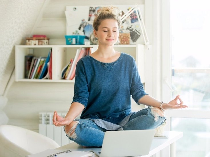 Teen studying laptop