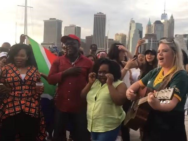 image south africans singing national anthem New York