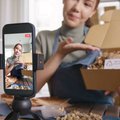 Social media user recording an unboxing video