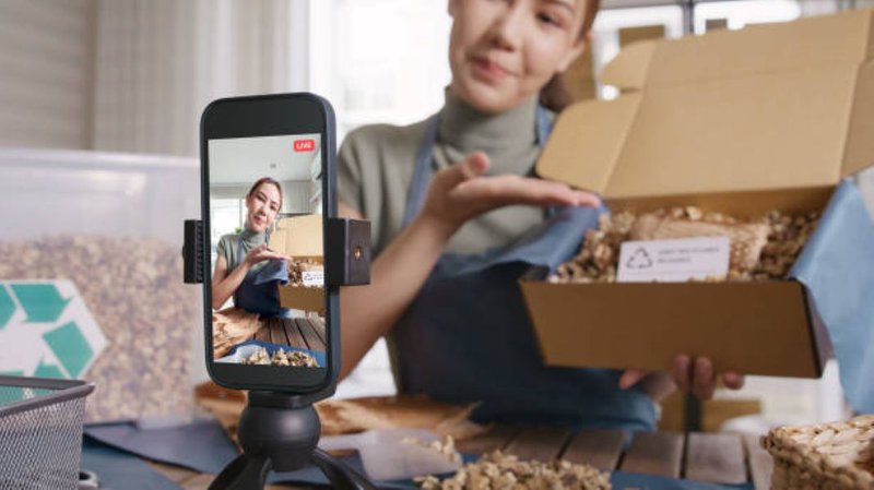 Social media user recording an unboxing video