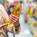 Lady carrying cooking oil in a store generic image
