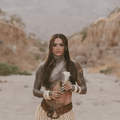 kehlani holds a white flower