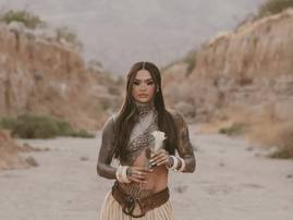kehlani holds a white flower