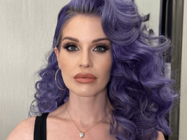 Kelly Osbourne with long curly purple hair