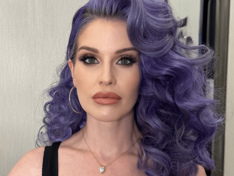 Kelly Osbourne with long curly purple hair