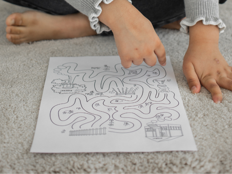 kid solving printed puzzle