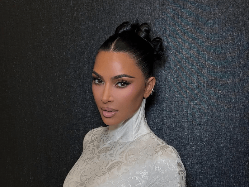 Kim Kardashian wearing a white top with a high neckline