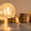 lit light bulb with gold coins
