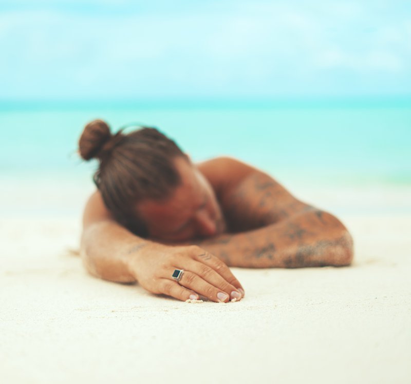 man lying on beach