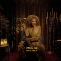 Spice Girls star Mel B holding a mask