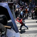 A protester hits a police crane during a protest by teachers ahead of the 2026 FIFA World Cup in Mexico