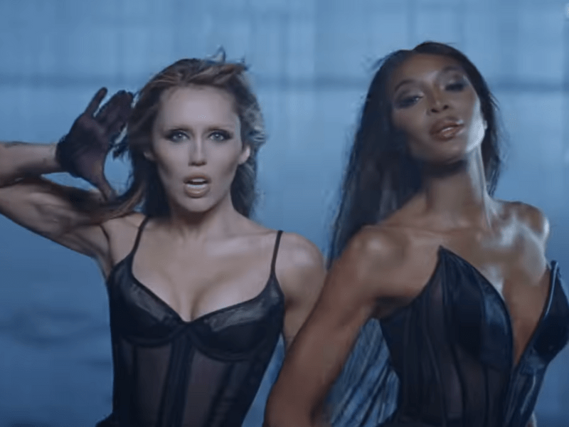 Miley Cyrus and Naomi Campbell wearing matching black outfits