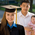 woman graduates while husband and baby watch