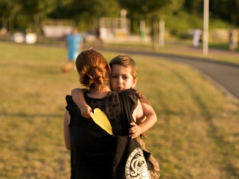 mom holding son to school