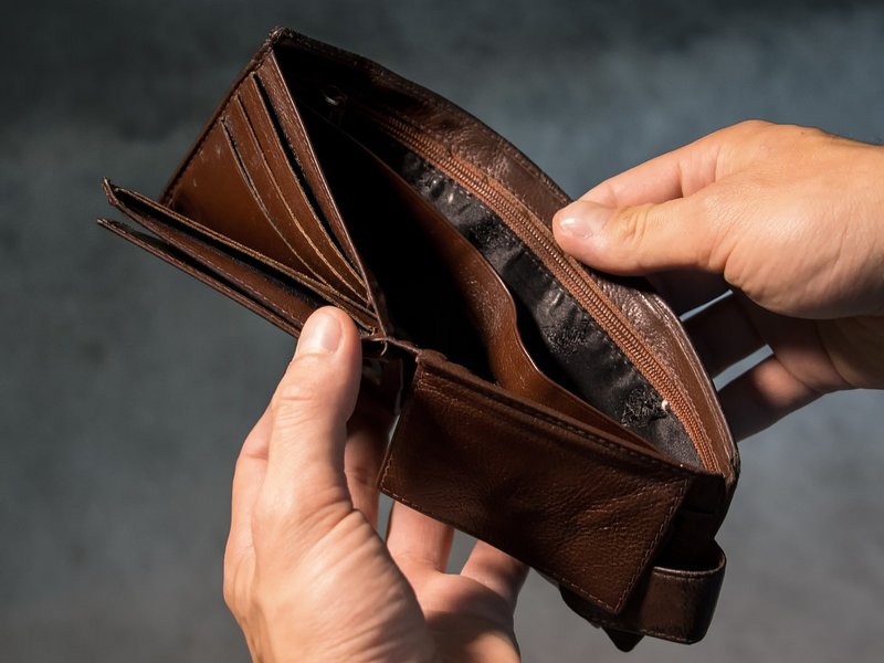 A an empty wallet held by a man