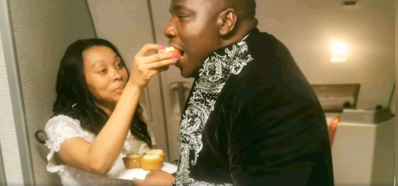 newly weds on flight eating cake