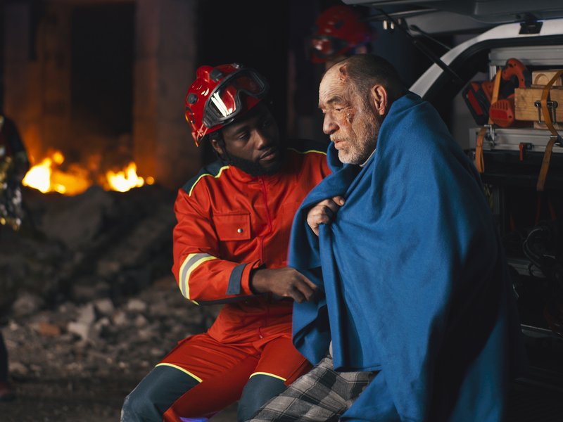 Paramedic speaking with survivor