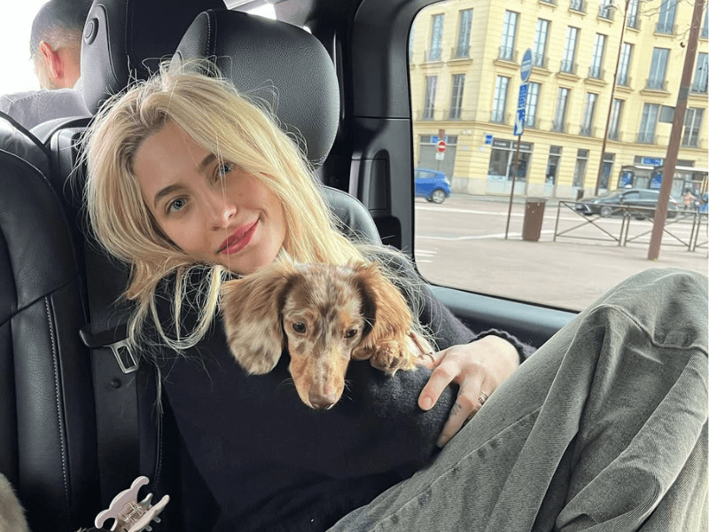 Paris Jackson carrying a dog
