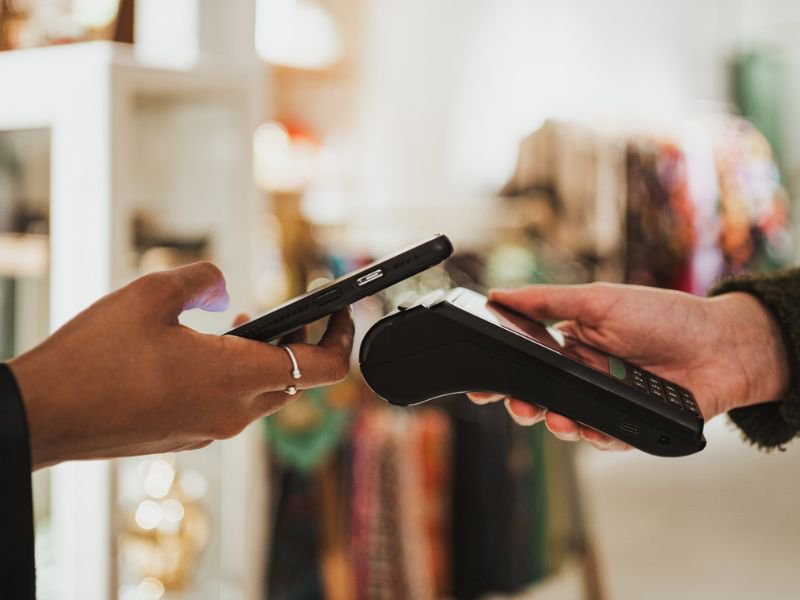 Person paying bill using phone