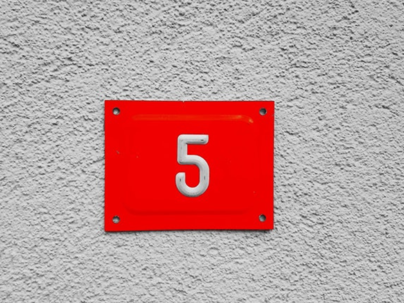 photo of the number five on a red plate