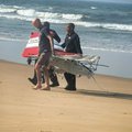 Durban Search and Rescue teams carry a piece of the plane wreckage