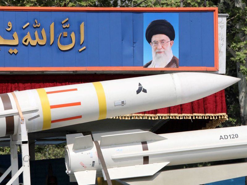 Iranian military truck carries parts of missile past portrait of supreme leader Ayatollah Ali Khamenei