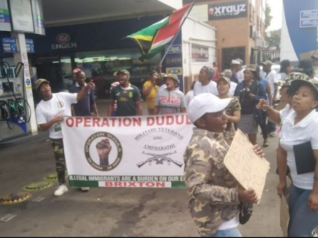 Operation Dudula members protest against foreign nationals outside an Engen garage in Brixton.