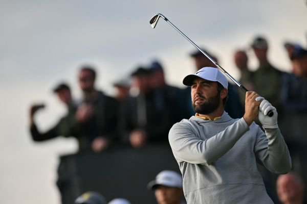 US golfer Scottie Scheffler watches his iron shot on the 16th tee