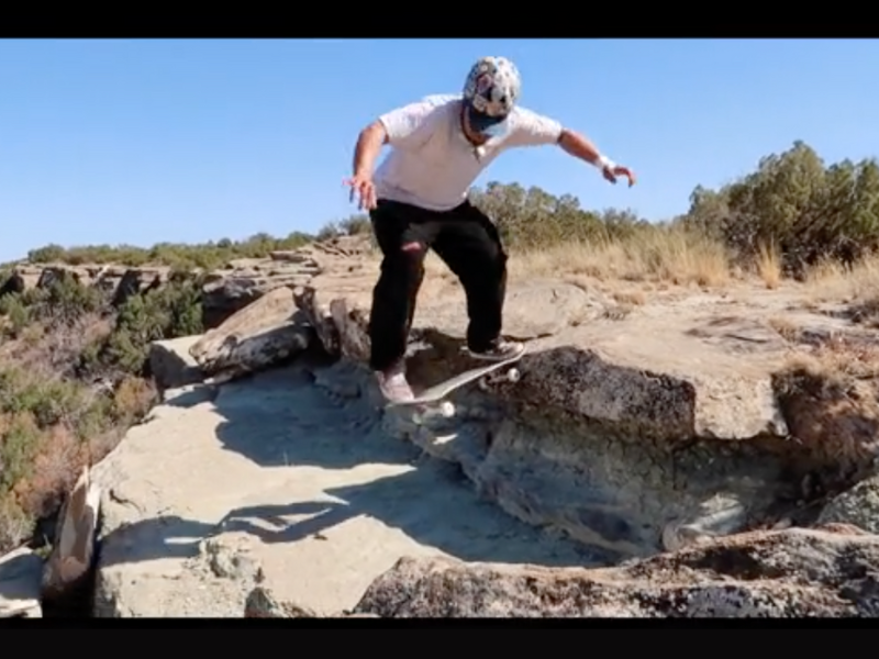 Skateboarder falls off cliff doing trick