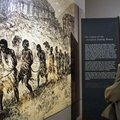 A man looks at slavery images in the Cape-Coast Castle in Ghana