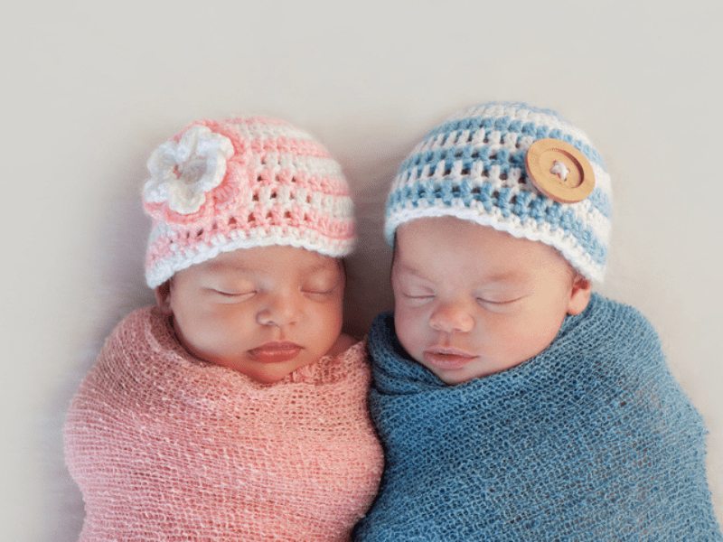 sleeping boy and girl fraternal twin newborn babies