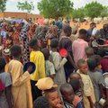 Women and children queue to receive free food in Sudan