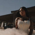 Summer Walker wearing a white lace wedding style dress with a full tulle skirt