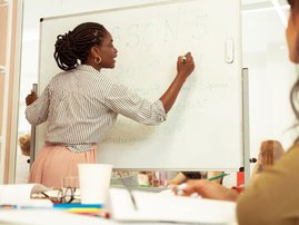 Teacher writing on board