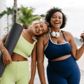two  fitness women standing on the beach promenade