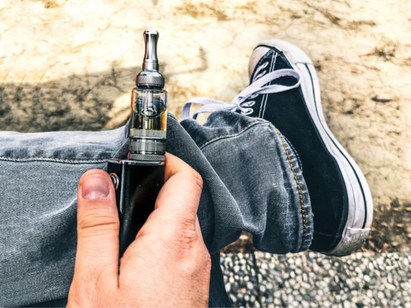 Man holding vape in hands