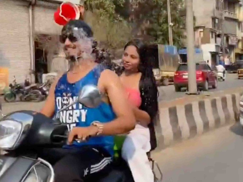 WATCH: Man and lady passenger have an illegal shower mid-scoot