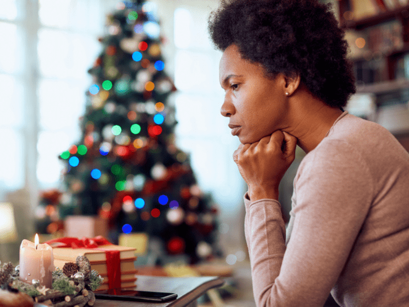 woman deep sits near a christmas tree