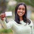 woman holding card and smiling
