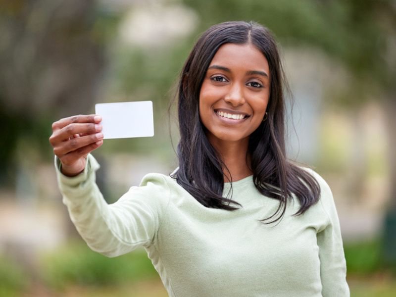 woman holding card and smiling