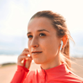 woman in sportswear listening to music
